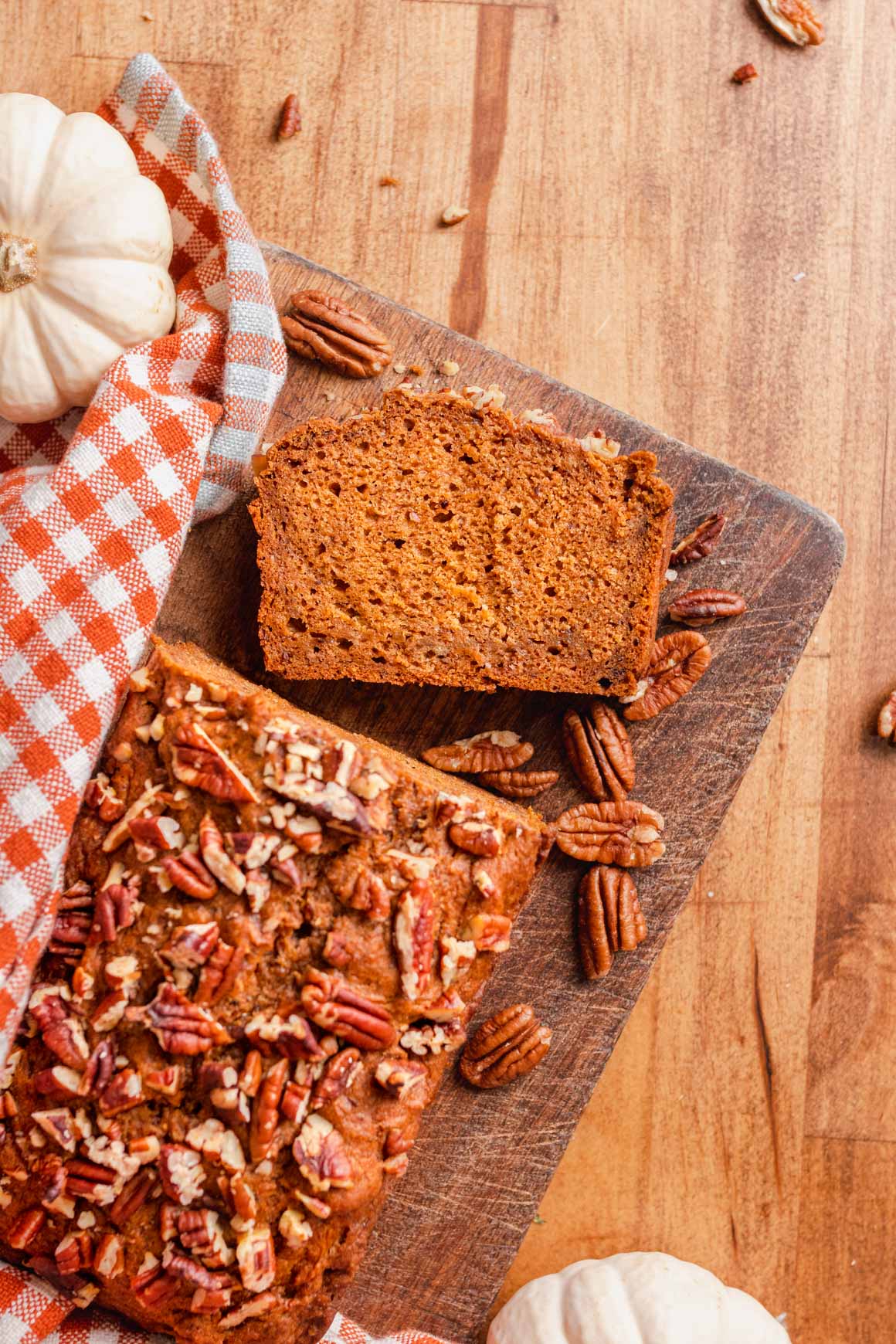 Slice of vegan pumpkin loaf with pecans