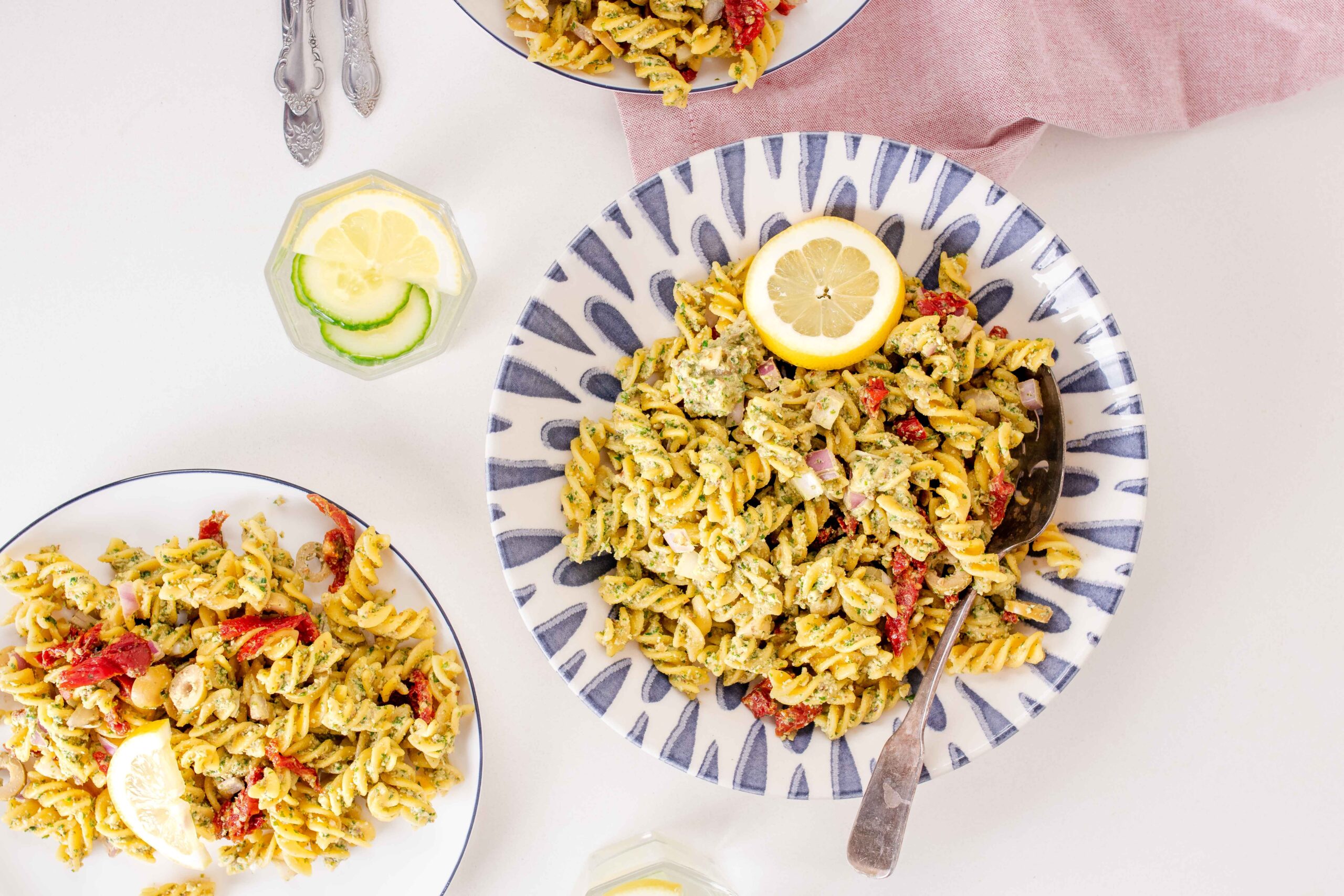 fusilli pasta with pesto, red onion, olives, sundried tomatoes and lemon slice